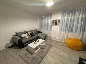 a living room with a couch and a table at Beautiful 2 Bedroom On Tower Bridge in London