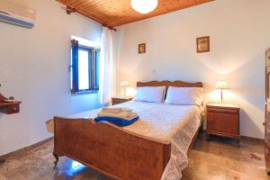 a bedroom with a large bed with two night stands at Old Stone House in Nisaki +66 photos