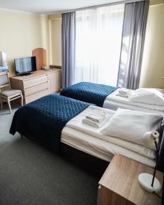 Łóżko lub łóżka w pokoju w obiekcie Ośrodek Konferencyjno-Wypoczynkowy "Parzenica" w Zakopanem