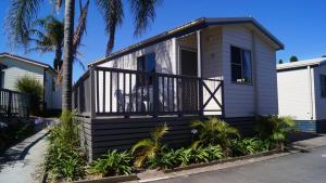 a small house with a balcony on a street at Lifestyle Villages Redhead in Redhead