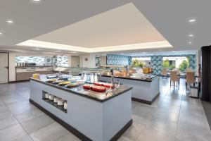 a kitchen with a counter with food on it at Occidental Roca Negra - Adults Only in Agaete
