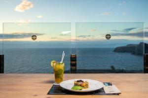 a plate of food on a table with a drink at Occidental Roca Negra - Adults Only in Agaete