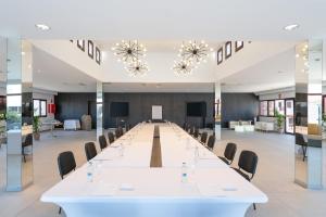 a large conference room with a long table and chairs at Occidental Roca Negra - Adults Only in Agaete