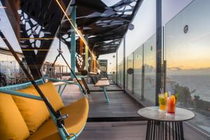 a balcony of a restaurant with a view of the ocean at Occidental Roca Negra - Adults Only in Agaete