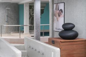 a black rock sitting on top of a wooden box at Occidental Roca Negra - Adults Only in Agaete