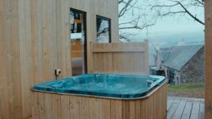 a hot tub on the side of a building at Boreland Loch Tay in Aberfeldy