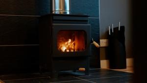 a black stove with a fire in it at Boreland Loch Tay in Aberfeldy +89 photos
