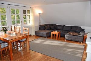 a living room with a couch and a table at Reetdachfachwerkvilla am Wiesengrund in Bergen auf Rügen