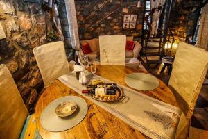 a wooden table with a plate on top of it at Charming 3-storey Loft with fireplace in Palaios Agios Athanasios