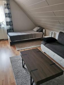 a living room with a bed and a couch at 5 minutes from the fair in Hannover