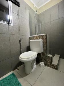 a bathroom with a white toilet in a room at Avalon Apartments in Puerto Iguazú