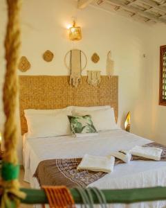 a bedroom with a large bed with towels on it at Pousada Tangerina in Icaraí +89 photos