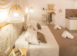 a bedroom with a large bed with pillows on it at Stella Maris - Formentera Break in Playa Migjorn