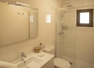 a bathroom with a shower and a sink and a toilet at Stella Maris - Formentera Break in Playa Migjorn +54 photos