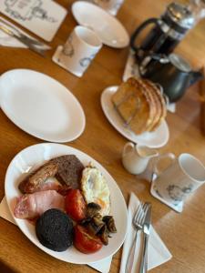 a table with a plate of breakfast food on it at Forsinard Lodge in Forsinard