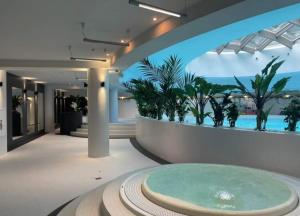 a room with a large pool in the middle of a building at Szczecin Hanza Tower APARTMENT-BASEN in Szczecin