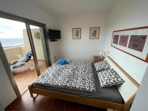 a bedroom with a bed and a view of the ocean at Seaview Cabezo flat fully equipped with parking in El Médano