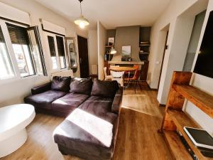 a living room with a couch and a table at Casa Rural Valsain Lodge -Piscina abierta! in La Pradera de Navalhorno