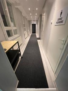 a hallway of an office with a black carpet at Kuukkeli Ivalo Airport Inn in Ivalo