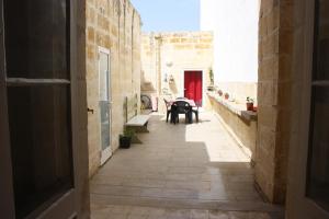 an alley with a table and benches in a building at VERTICAL CLIMBING MALTA in Qrendi