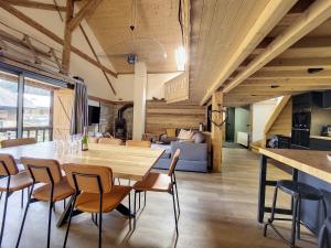 a dining room with a wooden table and chairs at Green Marmottes Chalet - 12 personnes - Pied des pistes - Saint Jean D Aulps in Saint-Jean-d'Aulps