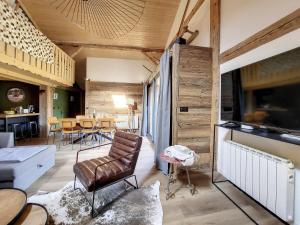 a living room with a couch and a table at Green Marmottes Chalet - 12 personnes - Pied des pistes - Saint Jean D Aulps in Saint-Jean-d'Aulps