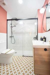 a bathroom with a shower and a toilet and a sink at Camino a la Playa in Gijón