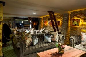 a living room with a couch and a brick wall at Temple Bar Inn in Dublin