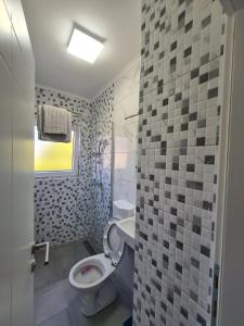 a bathroom with a toilet and a sink at Apartmani Bugojno in Bugojno