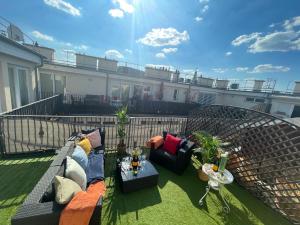 a balcony with a couch and chairs and a table at Exclusive Downtown Bella Home in Budapest
