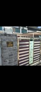 a building with a fence with a sign on it at Ann_HomeStay in Sandakan