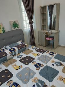 a bedroom with a bed with a bedspread with animals on it at Ann_HomeStay in Sandakan