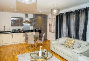 a living room with a couch and a table at DARTFORD LUXURY 2 BED APARTMENT in Kent
