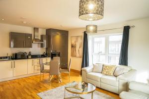 a living room with a couch and a table at DARTFORD LUXURY 2 BED APARTMENT in Kent
