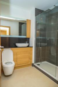 a bathroom with a toilet and a sink and a shower at DARTFORD LUXURY 2 BED APARTMENT in Kent