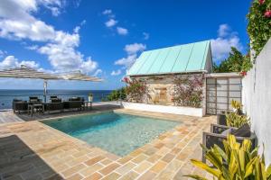 a swimming pool in a villa with a view of the ocean at CeBlue Villas in The Valley