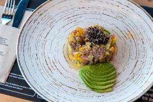 a white plate with food on a table at Occidental Roca Negra - Adults Only in Agaete