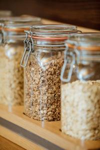 four glass jars of oats on a wooden shelf at Bayerischer Hof Spalt in Spalt