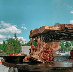 a piece of meat is cooking on a grill at Bayerischer Hof Spalt in Spalt