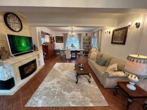 a living room with a couch and a fireplace at The View Sinaia-Busteni in Buşteni