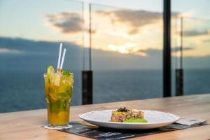 a plate of food and a drink on a table at Occidental Roca Negra - Adults Only in Agaete