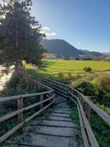 a wooden fence next to a tree and a field at b&b Aurora in Atina