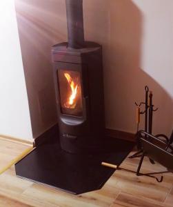 a stove in a room with a fire in it at Vikendica IVA in Pale