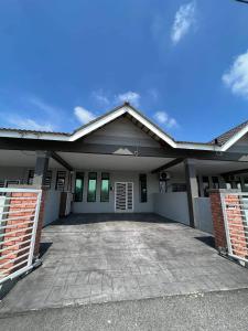 a house with a driveway in front of it at Homestay Kemaman Fyna06 in Kemaman