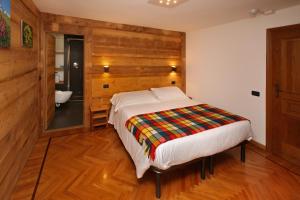 a bedroom with a bed and a bathroom at Hotel Biancaneve in Sauze dʼOulx