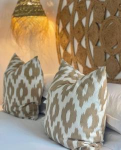 a bed with three pillows on it at Harbour View House in St Ives