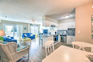 a kitchen and living room with a couch and chairs at Emerald Isle Condo with Indoor Pool and Beach Access! in Emerald Isle