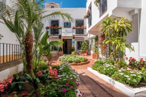 a courtyard of a building with flowers and plants at Dreams of Marbella in Marbella