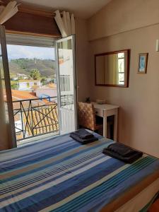 Schlafzimmer mit einem Bett und Blick auf einen Balkon in der Unterkunft Casa Azul in Odeceixe