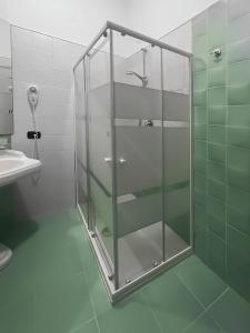 a glass shower in a bathroom with a sink at Vanvitelli Home in Caserta
